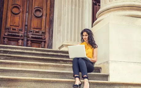 woman with a laptop in stairs